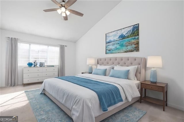 carpeted bedroom with ceiling fan and vaulted ceiling