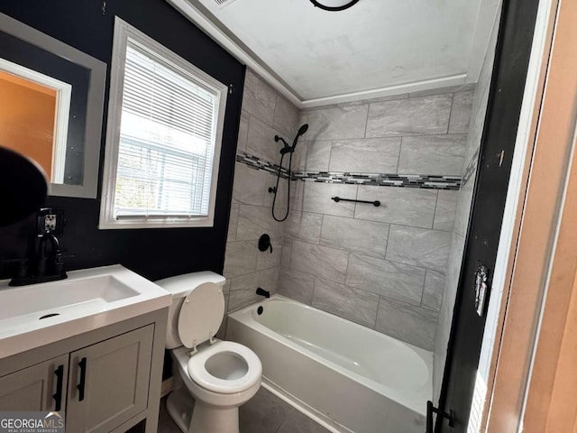 full bathroom with tiled shower / bath, tile patterned flooring, vanity, and toilet