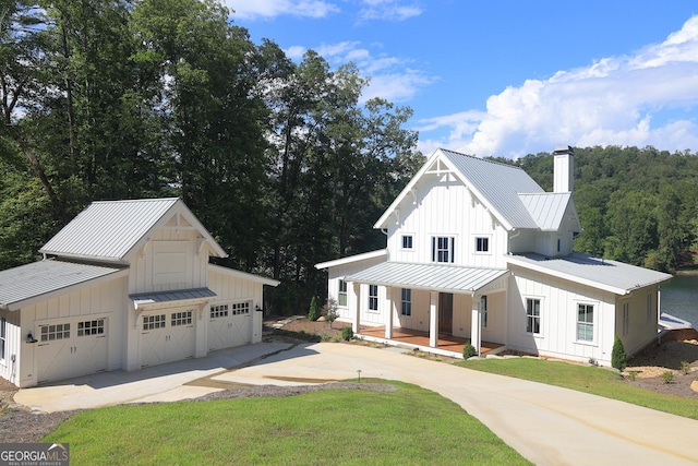 modern farmhouse featuring a porch and a front lawn