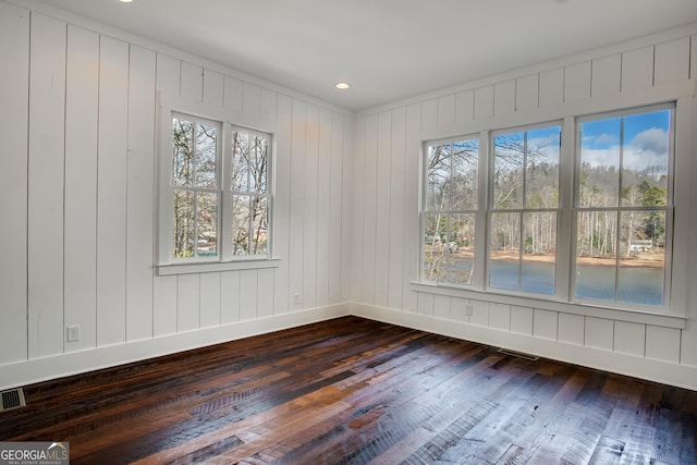 unfurnished room featuring hardwood / wood-style flooring