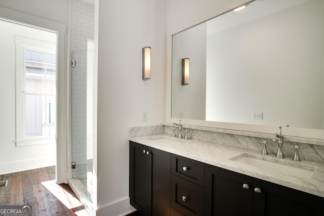 bathroom featuring vanity, wood-type flooring, and an enclosed shower