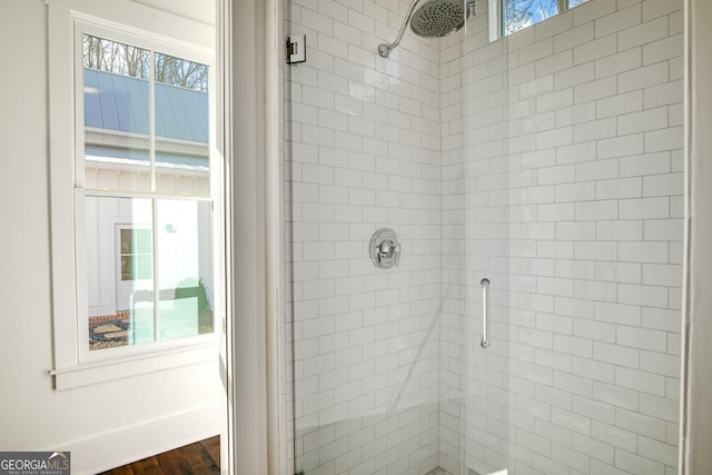 bathroom featuring an enclosed shower and wood-type flooring