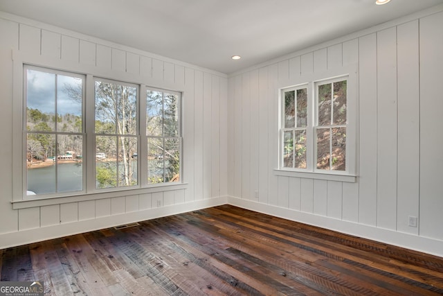 spare room with wood-type flooring