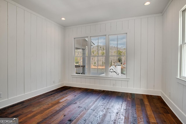 spare room featuring wood-type flooring