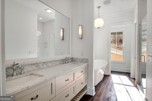 bathroom featuring vanity, wood-type flooring, and independent shower and bath