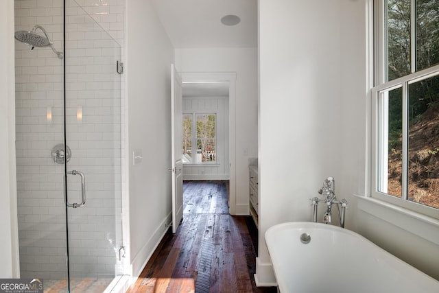 bathroom featuring vanity, hardwood / wood-style flooring, and independent shower and bath