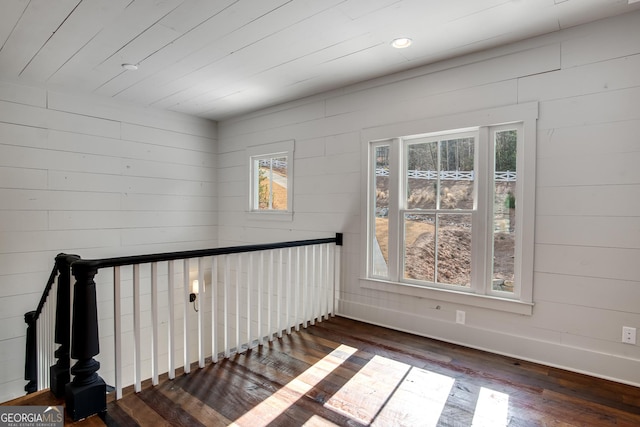 interior space featuring wooden walls, hardwood / wood-style floors, and wood ceiling