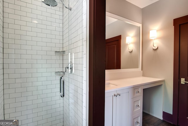 bathroom with vanity, wood-type flooring, and walk in shower