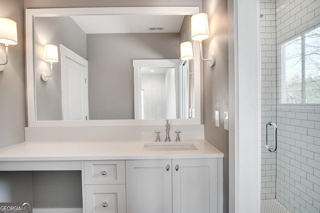 bathroom with vanity and a shower with door