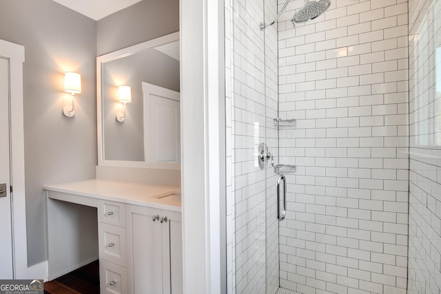 bathroom featuring vanity and a shower with shower door