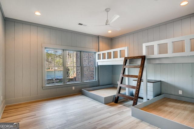 unfurnished bedroom featuring hardwood / wood-style flooring and ceiling fan