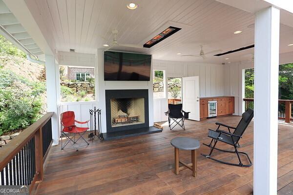 exterior space with ceiling fan and beverage cooler