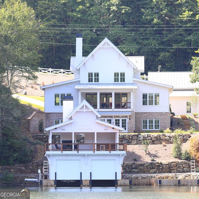 rear view of property featuring a balcony