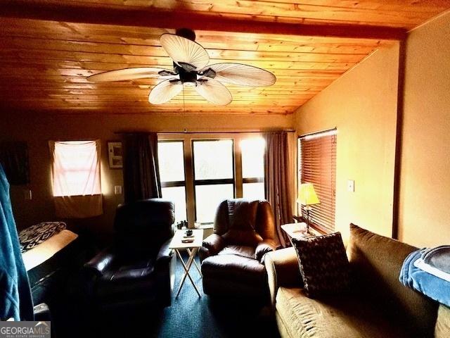 living room with vaulted ceiling, ceiling fan, and wooden ceiling