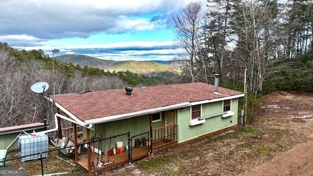 back of property featuring a mountain view