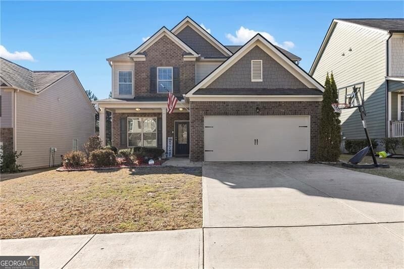 view of front of property with a front yard and a garage