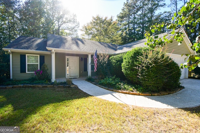 ranch-style home featuring a garage and a front lawn