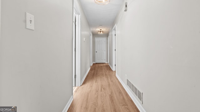 hall with light hardwood / wood-style flooring