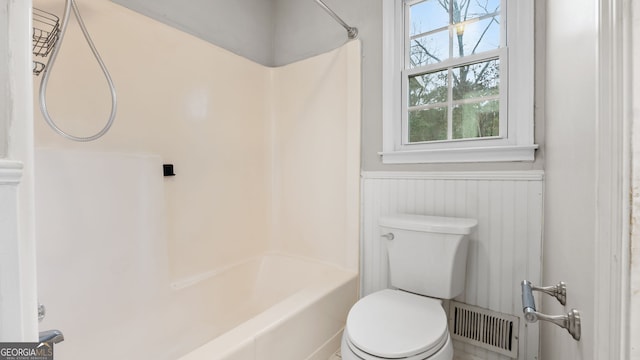 bathroom with toilet and bathtub / shower combination