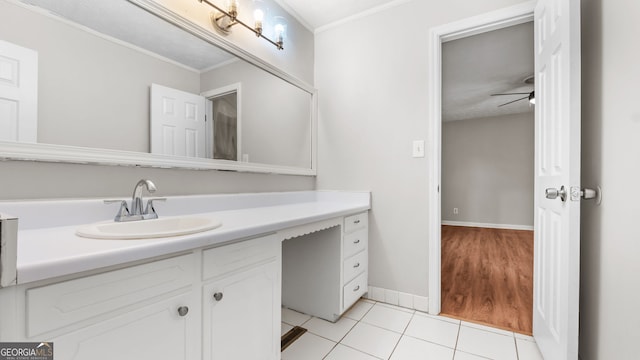 bathroom featuring ceiling fan, ornamental molding, tile patterned floors, and vanity