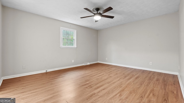 empty room with ceiling fan and light wood-type flooring