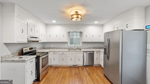 kitchen with appliances with stainless steel finishes, white cabinets, and sink