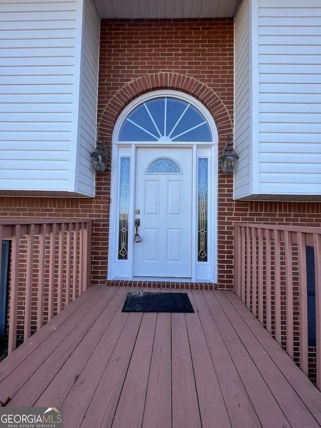 entrance to property with a wooden deck