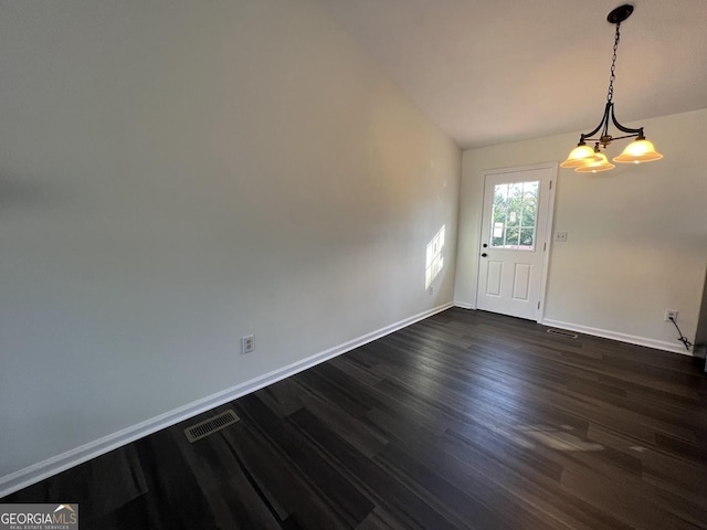 foyer entrance featuring a notable chandelier and dark hardwood / wood-style floors