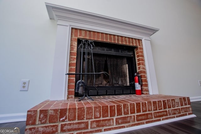 room details with hardwood / wood-style flooring and a fireplace