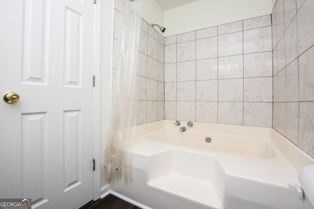 bathroom featuring tub / shower combination and tile walls