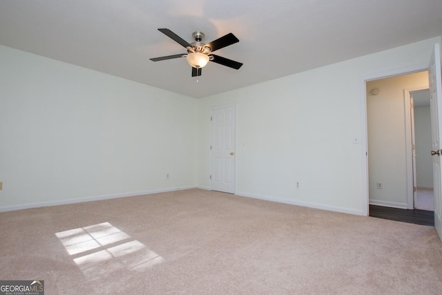 carpeted spare room with ceiling fan