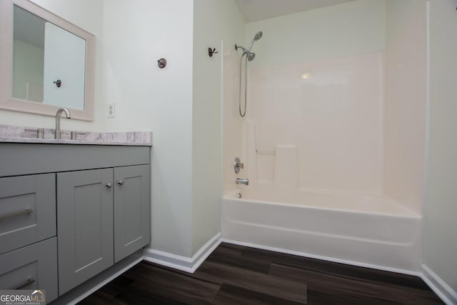 bathroom featuring shower / washtub combination, vanity, and hardwood / wood-style flooring