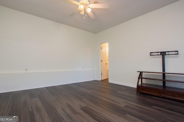 spare room featuring ceiling fan and dark wood-type flooring