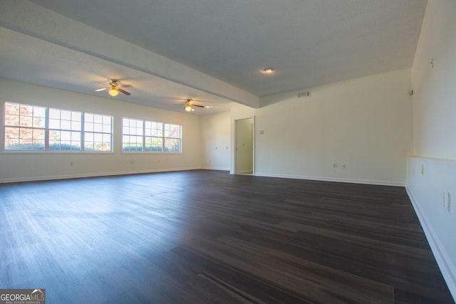 empty room featuring ceiling fan and dark hardwood / wood-style flooring