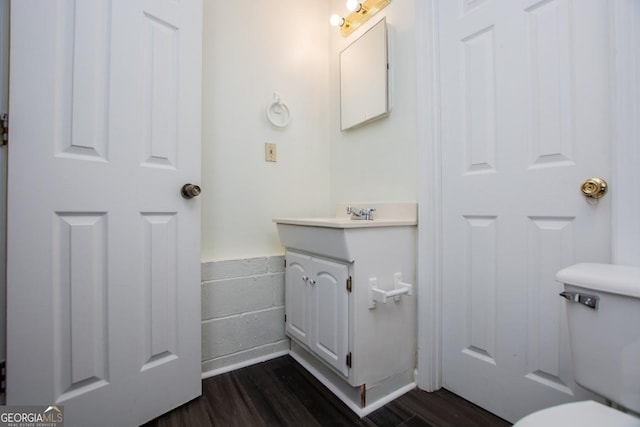 bathroom featuring hardwood / wood-style floors, vanity, and toilet