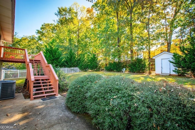 view of yard featuring central AC, a storage shed, and a deck