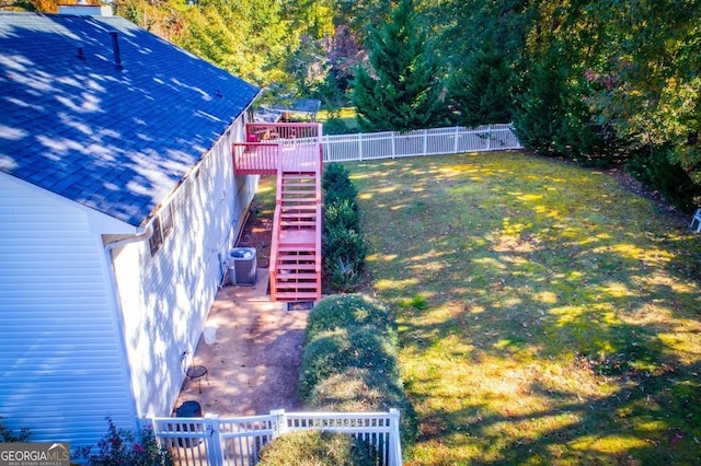 view of yard with cooling unit and a deck