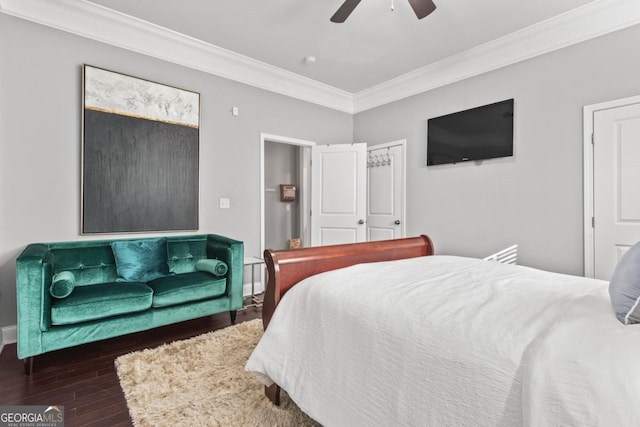 bedroom featuring dark hardwood / wood-style flooring, ceiling fan, and ornamental molding