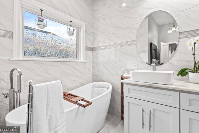 bathroom featuring vanity, tile walls, and a washtub