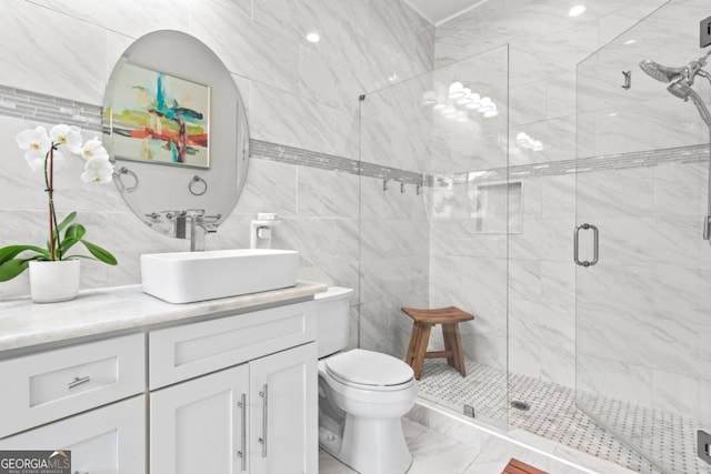 bathroom with vanity, toilet, and a shower with shower door