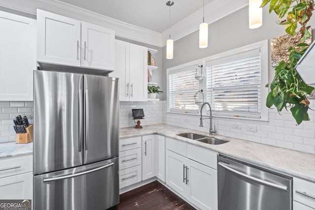 kitchen featuring decorative backsplash, appliances with stainless steel finishes, light stone counters, sink, and white cabinets