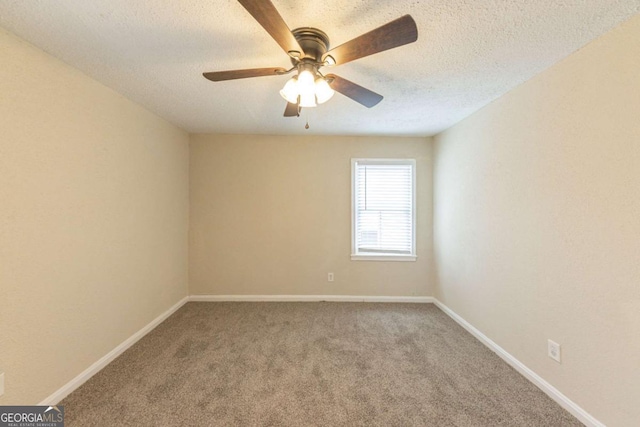 unfurnished room featuring ceiling fan, carpet, and a textured ceiling