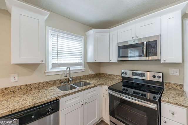 kitchen with white cabinetry, sink, and stainless steel appliances