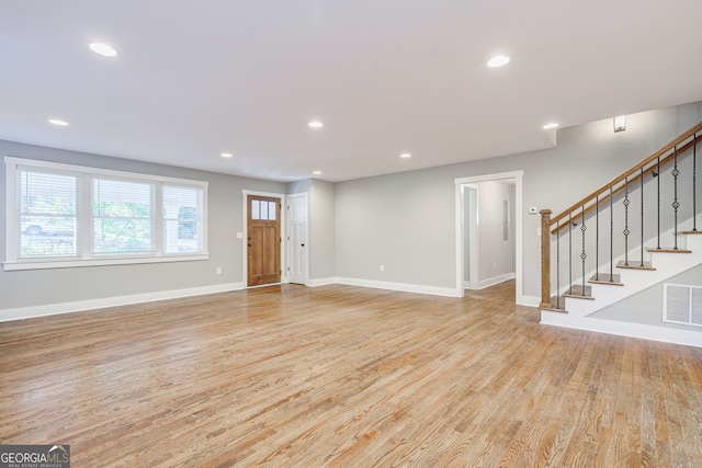 unfurnished living room with light hardwood / wood-style floors