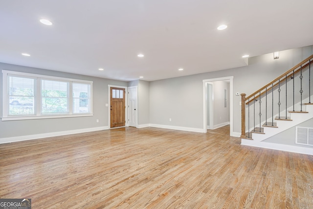 unfurnished living room featuring recessed lighting, visible vents, light wood-type flooring, and baseboards