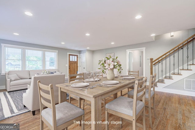 dining space featuring light wood finished floors, stairs, visible vents, and recessed lighting