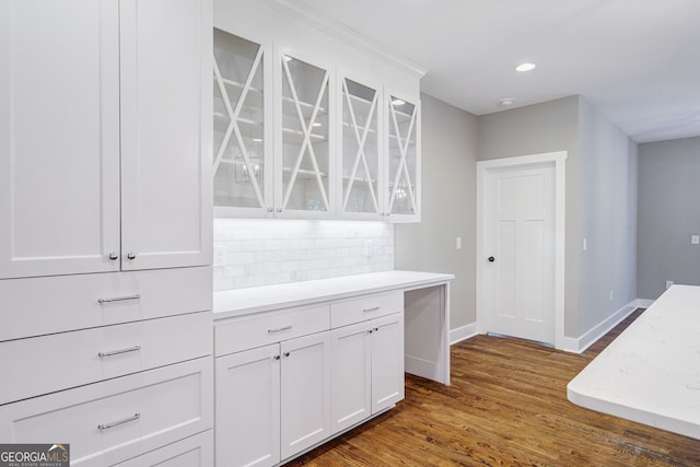 kitchen with white cabinets, decorative backsplash, and dark hardwood / wood-style floors