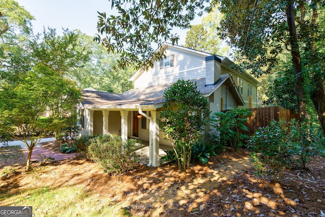 view of front of home featuring fence