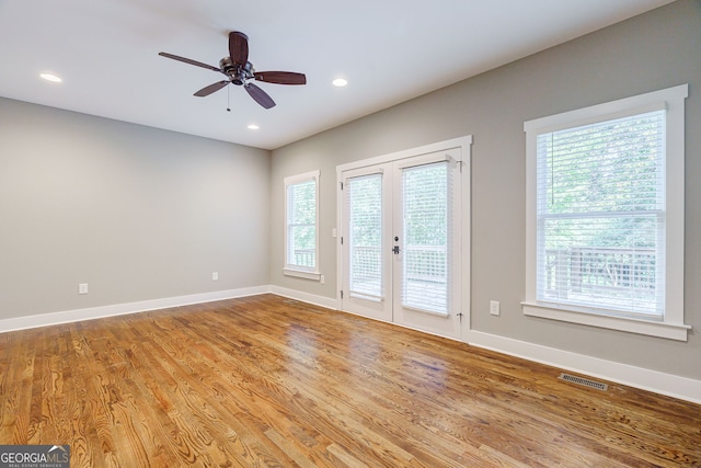 unfurnished room with french doors, light hardwood / wood-style floors, and ceiling fan