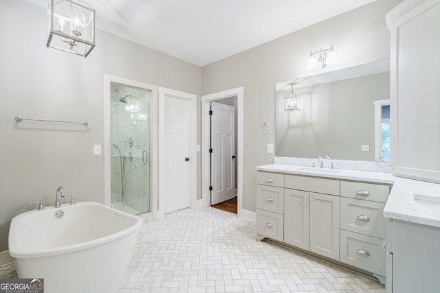 bathroom with a shower stall, a freestanding bath, and vanity